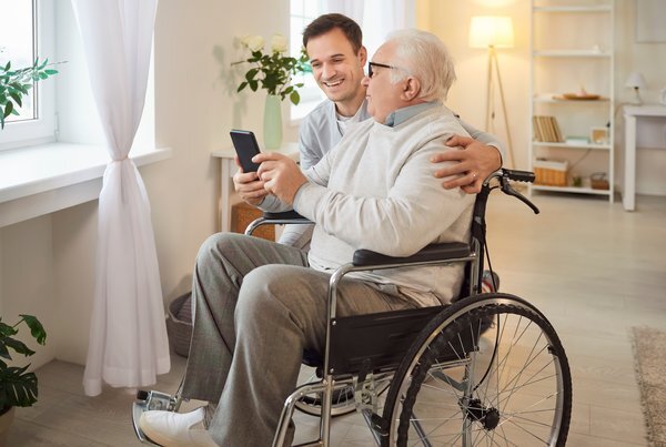 health-young-caregiver-elderly-man-wheelchair